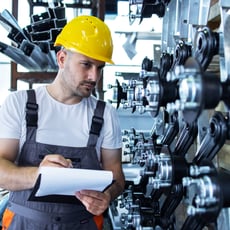 industrial-employee-wearing-uniform-yellow-hardhat-checking-production-factory