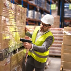 male-warehouse-worker-using-bar-code-scanner-analyze-newly-arrived-goods-further-placement-storage-department
